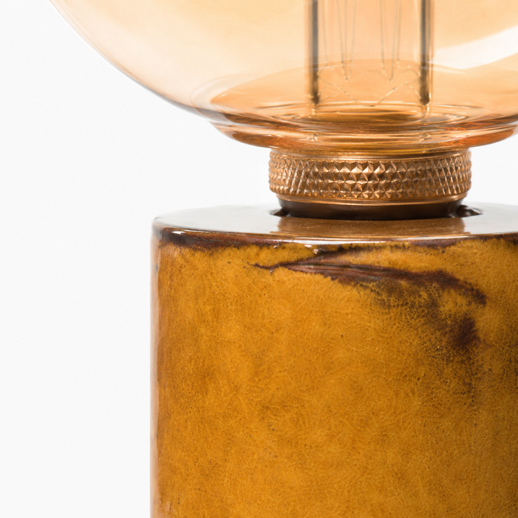 Extreme close-up macro detail of Table Lamp Jutta 2724Y showing amber glass globe texture, filament detail and natural wood grain finish at high resolution by Marcottestyle