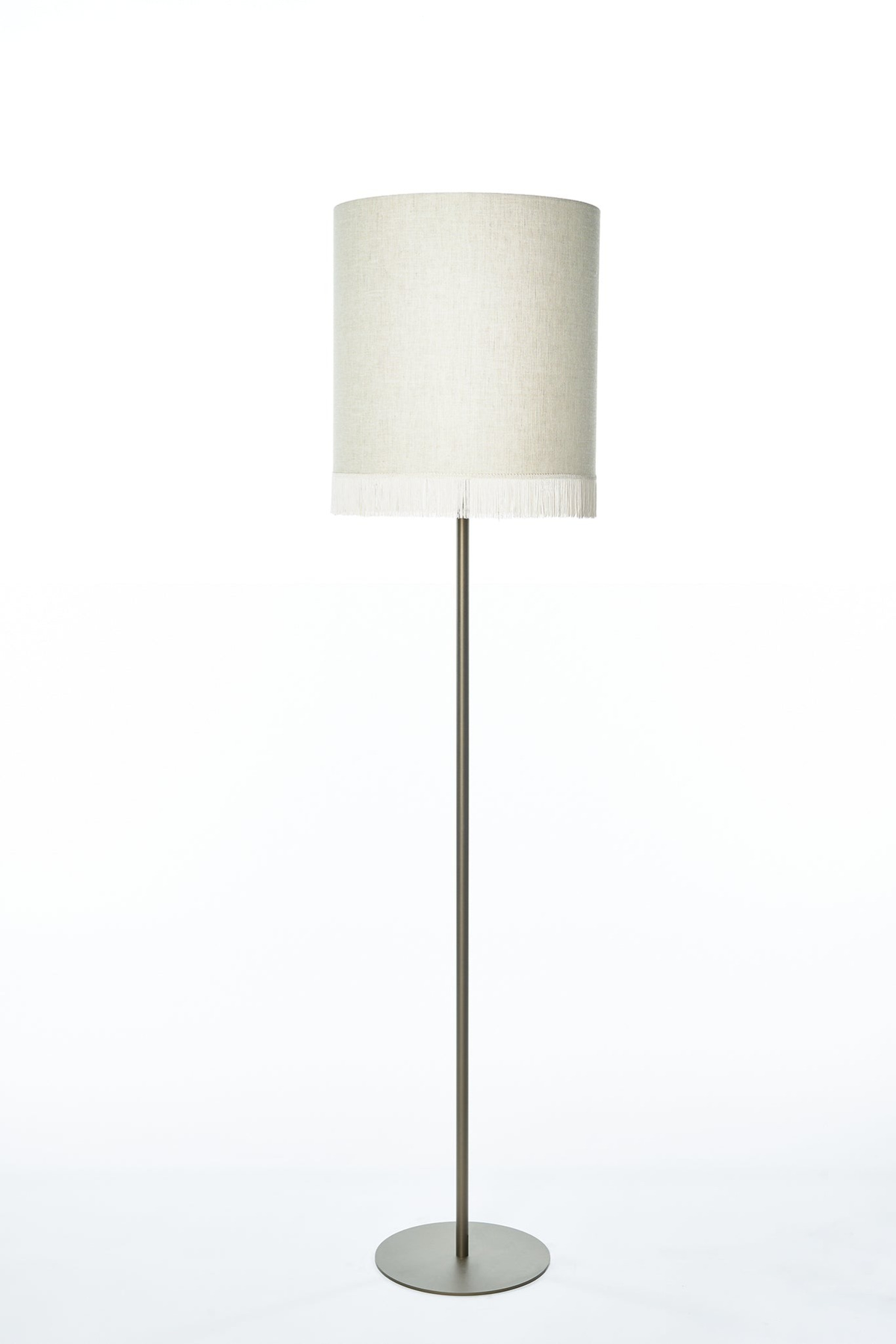 Floor Lamp Yara 5685K Bronze front view on white background with studio lighting, featuring bronze finish and cylindrical fabric shade with fringe detail, professional product photography by Marcottestyle