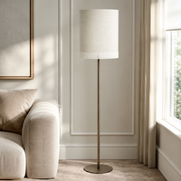Stehlampe Yara 5685K Bronze styled in a modern luxury living room mit velvet carpet, natural window light and realistic sunlight reflections, professional product photography by Marcottestyle